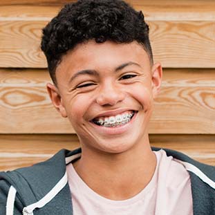 smiling teen boy wearing braces