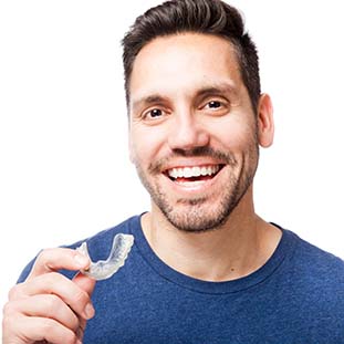 man holding a clear aligner