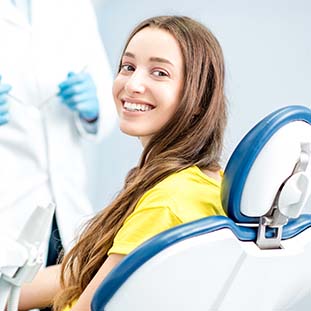 smiling girl sitting in a dental chair