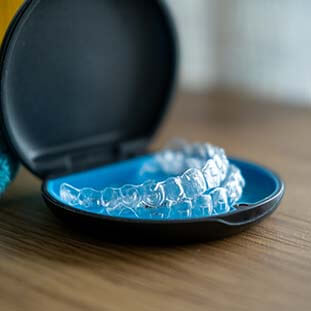 Invisalign aligners sitting in a tray