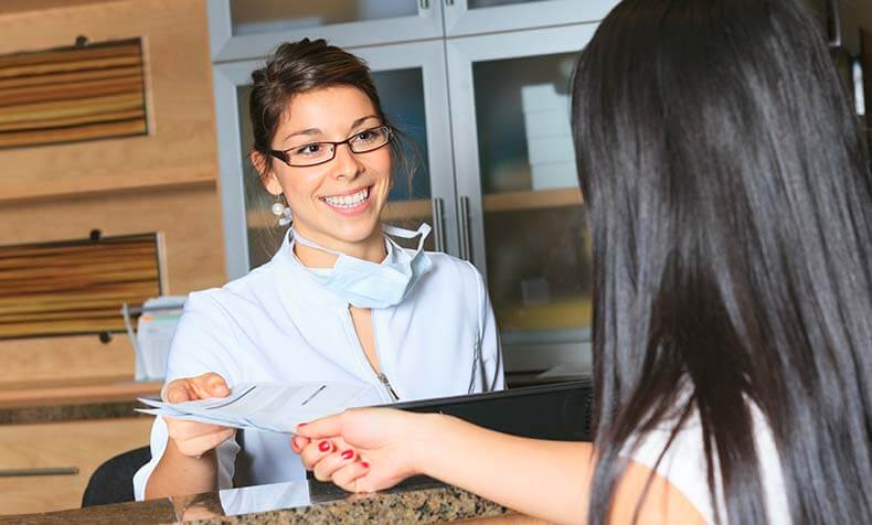 dental receptionist talking with a patient