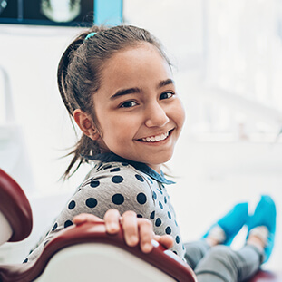 smiling girl sitting in a dental chair