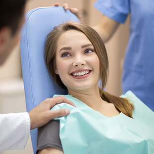 smiling girl sitting in a dental chair