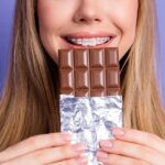 teen with braces eating candy at halloween